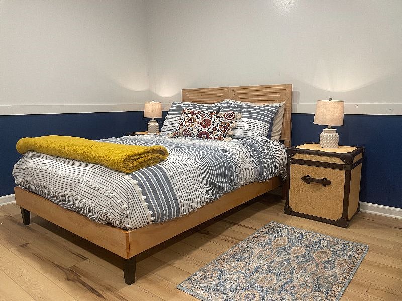 Full bed with new mattress and linens, bedside reading lamps and tables with storage

