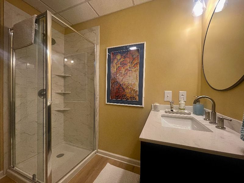Bright and cheery bathroom with glass shower and single vanity with lots of storage