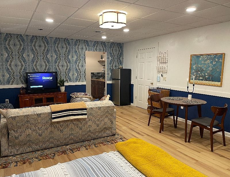 View of the apartment showing the sitting and dining areas as well as the interior entry way and entrance to the galley kitchenette
