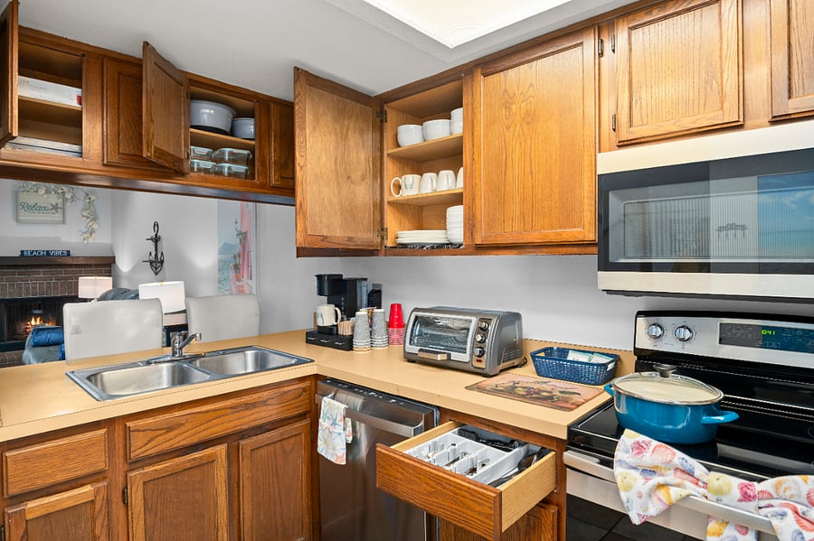 Our fully stocked kitchen equipped with: Glassware & mugs, Keurig drip coffee, Toaster Oven-Air Fyer, Ninja Blender, Pots, pans, paper plates, plastic cups, to go coffee cups, food storage containers, and more!
