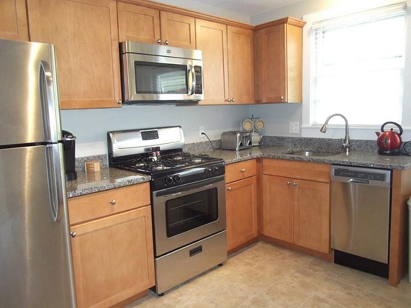 Stainless steel appliances with granite countertops.