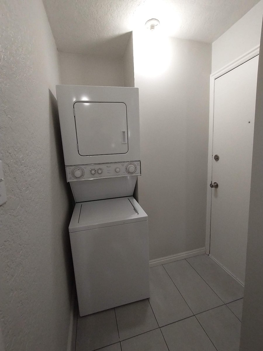 Shared use washer/dryer. The door leads to the exterior and a sidewalk that leads to the entry of the aparments