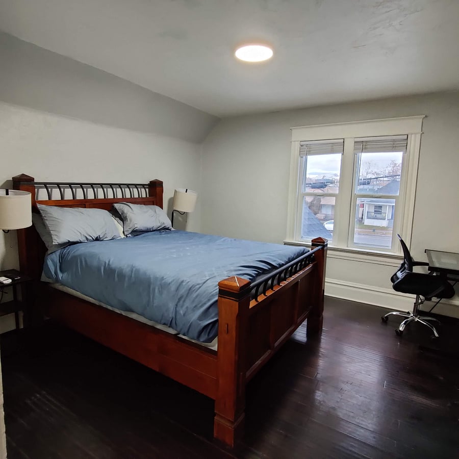 Bedroom includes a desk and chair for any work. Not pictured, just to the right of the photo is an armoire with a smaller TV on top