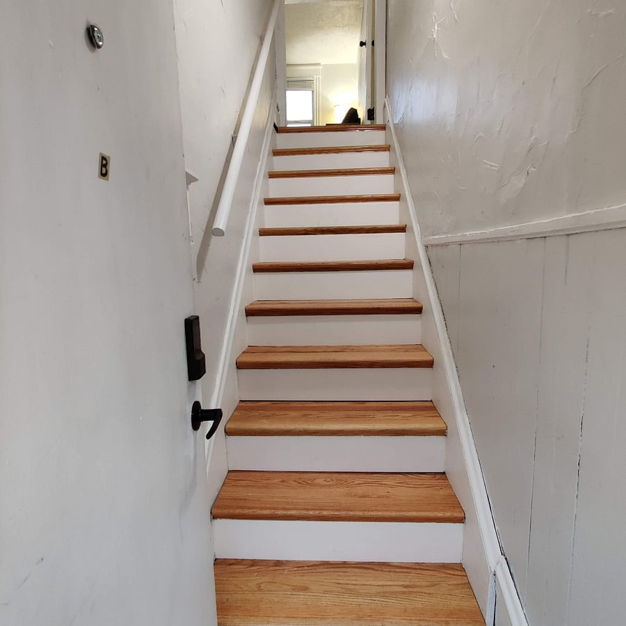 Interior stairway leading up to the apartment