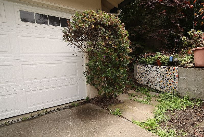 Notice the welcome mosaic.   :)   Follow the flagstone path to the right of the garage and continue down along the walkway.