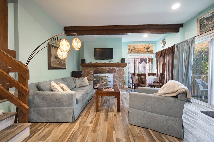 Living Room and dining table surrounded by large picture windows.