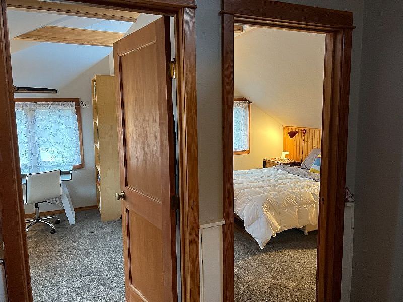 view of 2nd upstairs bedroom from hall/upstairs den. Both doors close