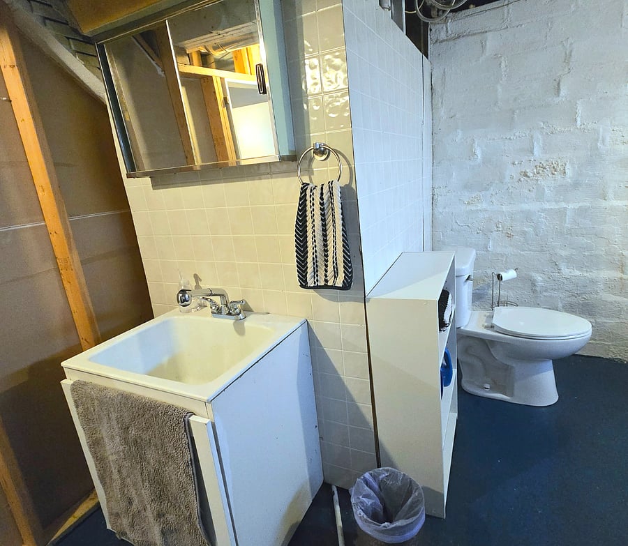 Laundry area and half bath located in basement