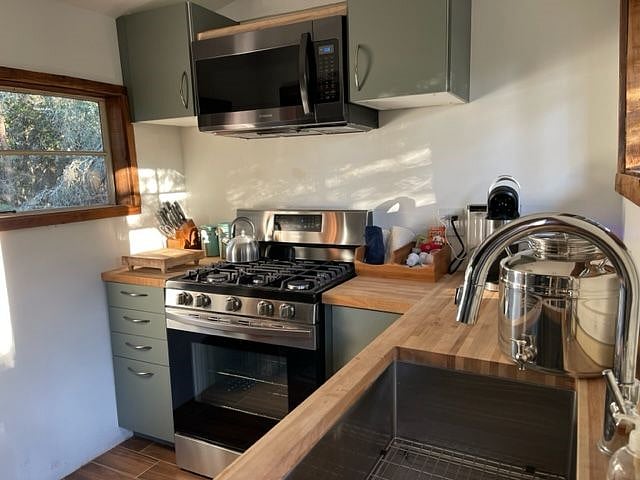 New kitchen with full size stove/oven, side/side fridge, microwave and deep professional sink.