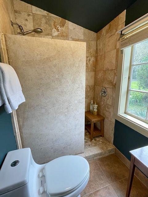 Walk in travertine shower with excellent water pressure.
