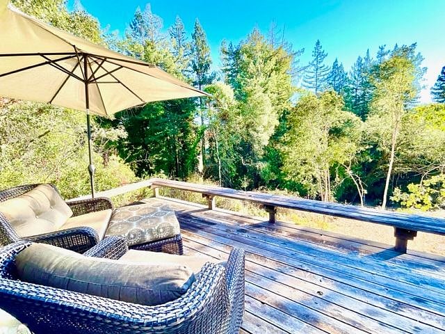 Enjoy the sounds of birds and the sunrise from the back deck with sunbrella cushions and adjustable shade umbrella.
