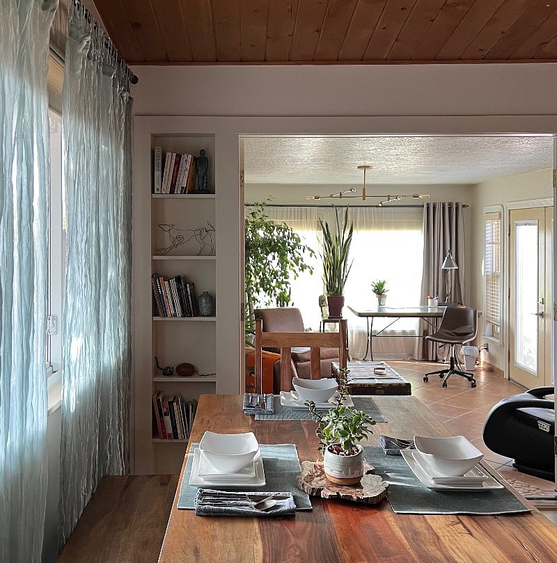 Sun room with desk/puzzle table by plants