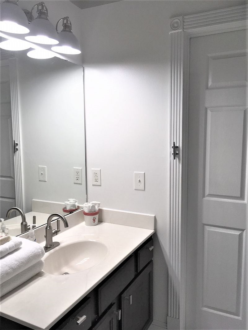 Full bath features tub and shower, with premium linens.