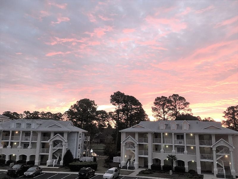Large, partially-covered balcony with sunset views! Overlooks pool, golf and 