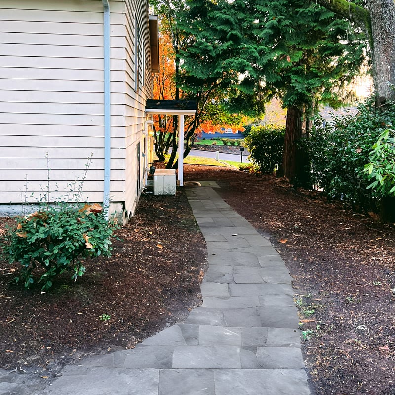 Walkway leading to guest entrance for basement unit.