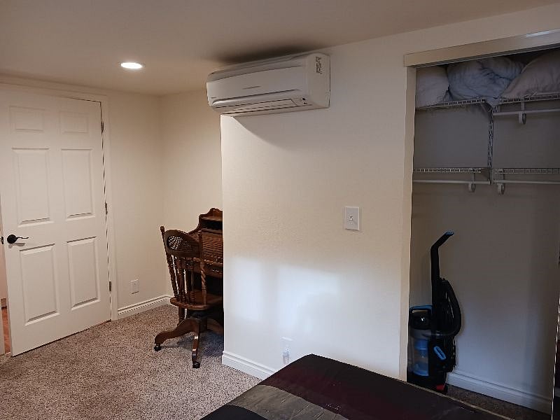 Ductless heat/AC unit, closet, desk in bedroom