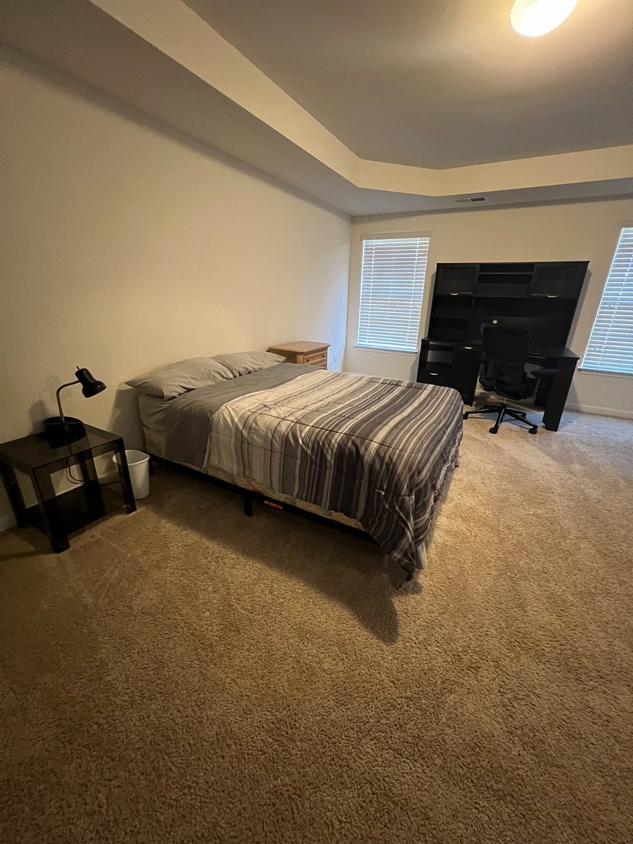Large downstairs bedroom with large walk in closet and private bathroom, including walk-in shower, bathtub, and double vanity.