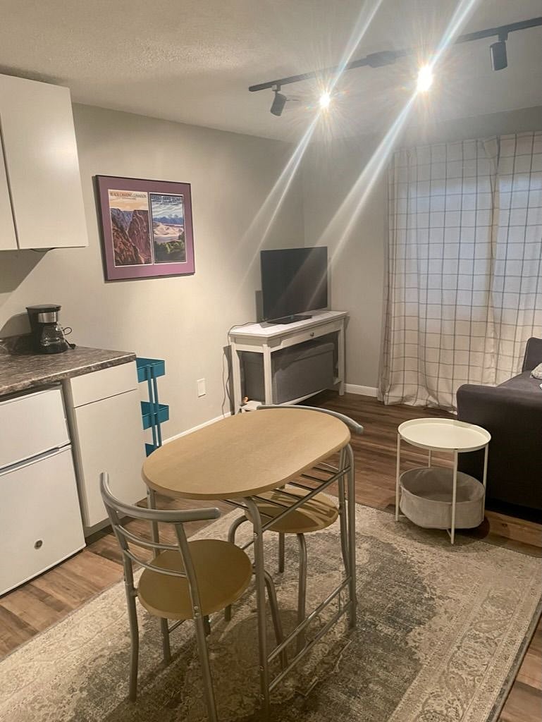 Multi-purpose sitting area/kitchenette with a small dining room table.