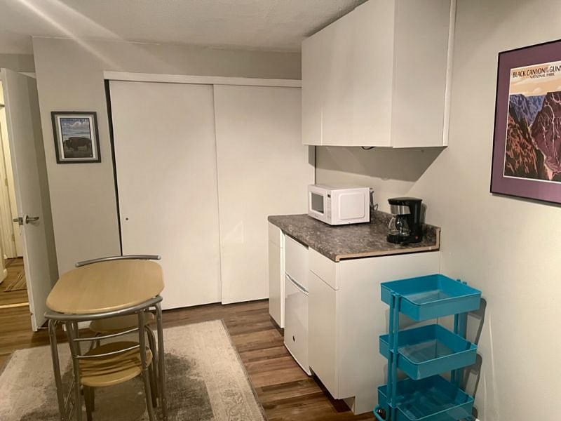 The downstairs living area has a kitchenette and dining room table that seats two.