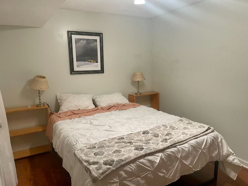 There is a queen size bed in the downstairs bedroom. The bedroom has french doors that open to the downstairs sitting area.