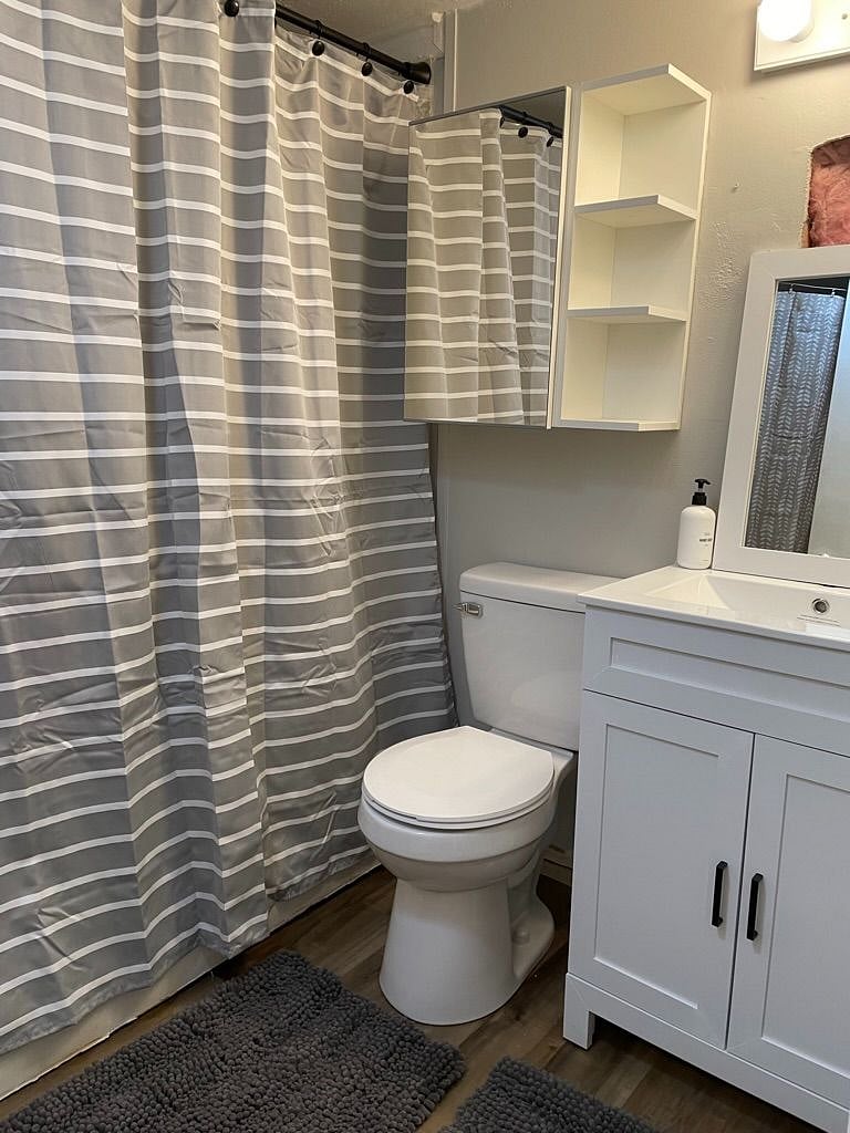 The downstairs bathroom is another full bath. This doubles as the washer/dryer room which is behind a curtain in the same space. 