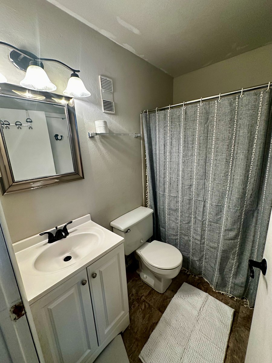 The upstairs bathroom shares a door with both the corridor and the master bedroom walk-in closet. This is a full bathroom.