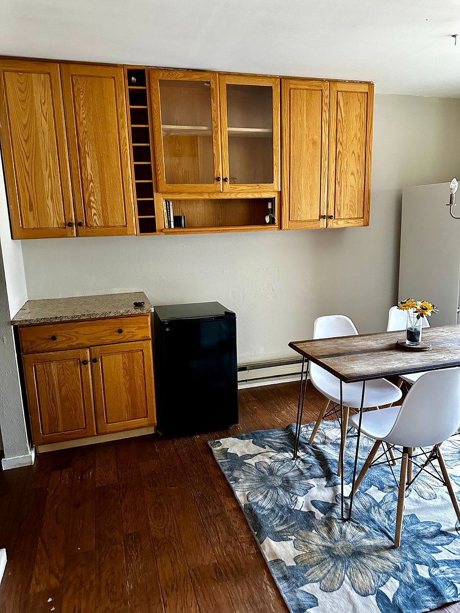 The dining room features additional cabinets, and currently, there is a second fridge for any overflow or extra items (when I lived in my condo it was affectionately referred to as 'the condiment fridge').