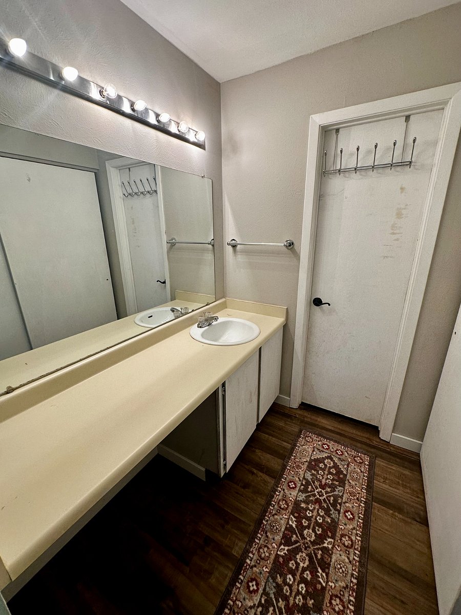 The master bedroom features a 'walk-in' area with counter space, an extra sink, and closet space.