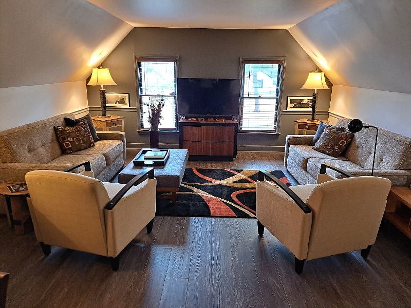 Mid Century Modern Living room. Pre-programmed Smart TV with Wi-fi and high speed internet. Both sofas fold out into double beds with new memory foam mattress toppers. Linens, pillows, and blankets for both sofa beds are stored in the drawers underneath the TV. New eco-friendly ductless HVAC units were installed in June 2022 and are programmable with a remote control.