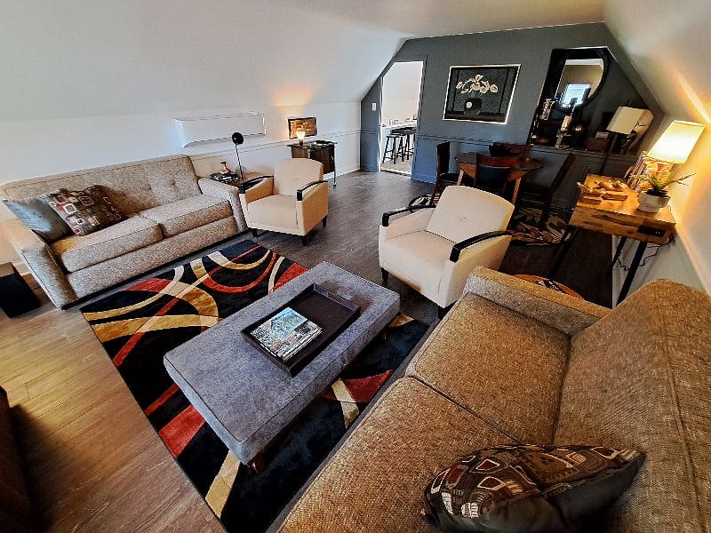 Mid Century Modern Living room. Pre-programmed Smart TV with Wi-fi and high speed internet. Both sofas fold out into double beds with new memory foam mattress toppers. Linens, pillows, and blankets for both sofa beds are stored in the drawers underneath the TV. New eco-friendly ductless HVAC units were installed in June 2022 and are programmable with a remote control.
