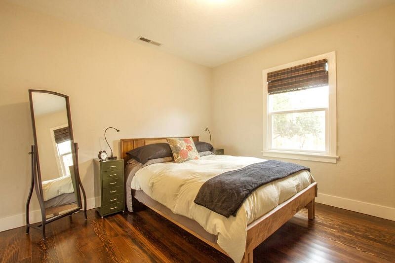There is a queen sized bed in the bedroom.