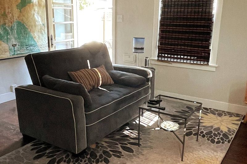 This couch is comfortable and can convert into a double bed should you need it. Across from the couch (not pictured) is a TV.