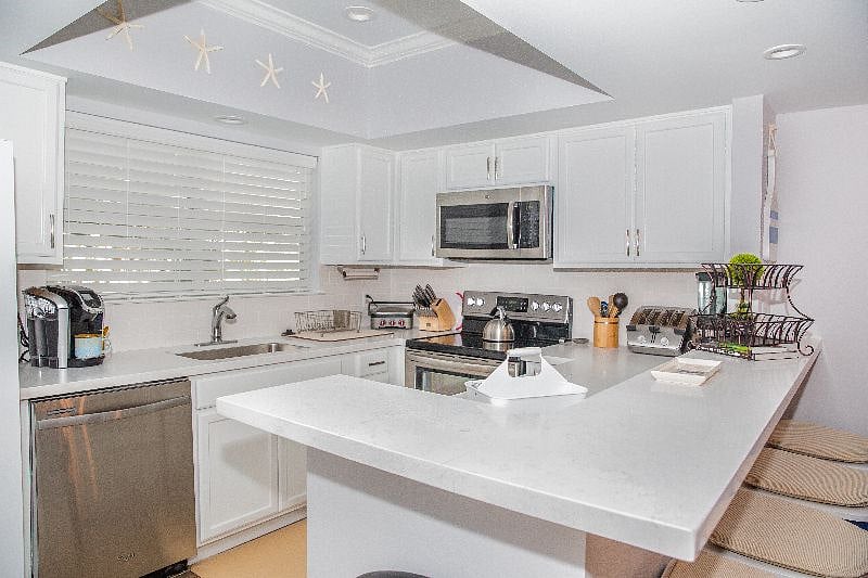 Kitchen stocked with all the pots and pans, utensils, and other cookware you need.