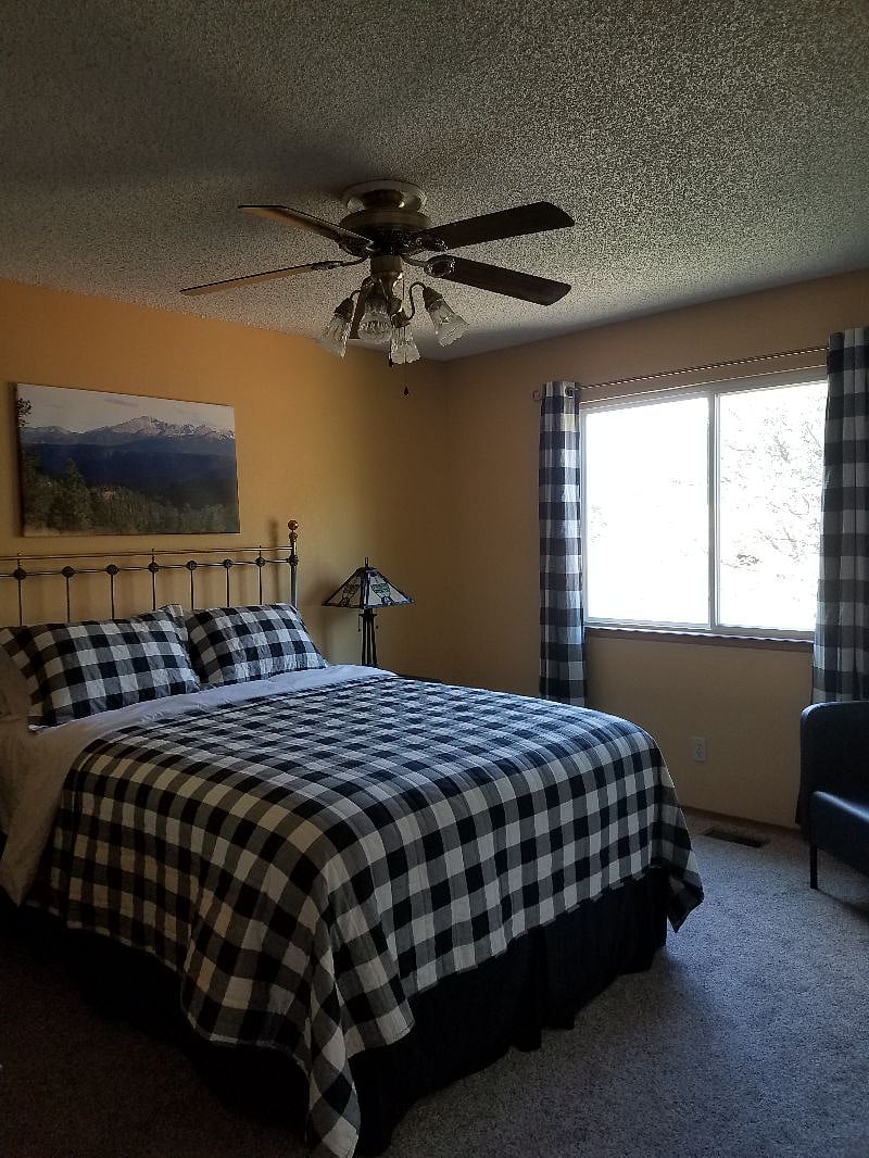 Queen bed with backyard, Air Force Academy, and mountain views