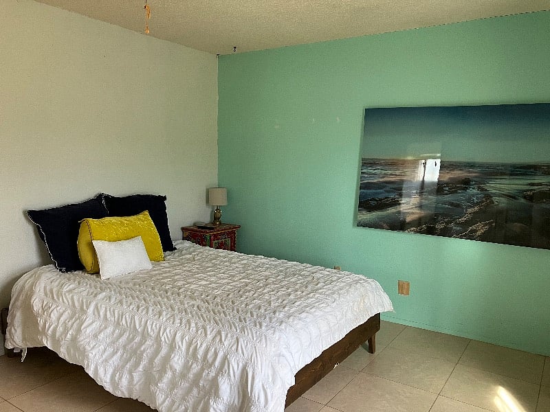 Second bedroom has a queen sized bed, television, side tables and a walk-in closet.
Handmade in India side tables.