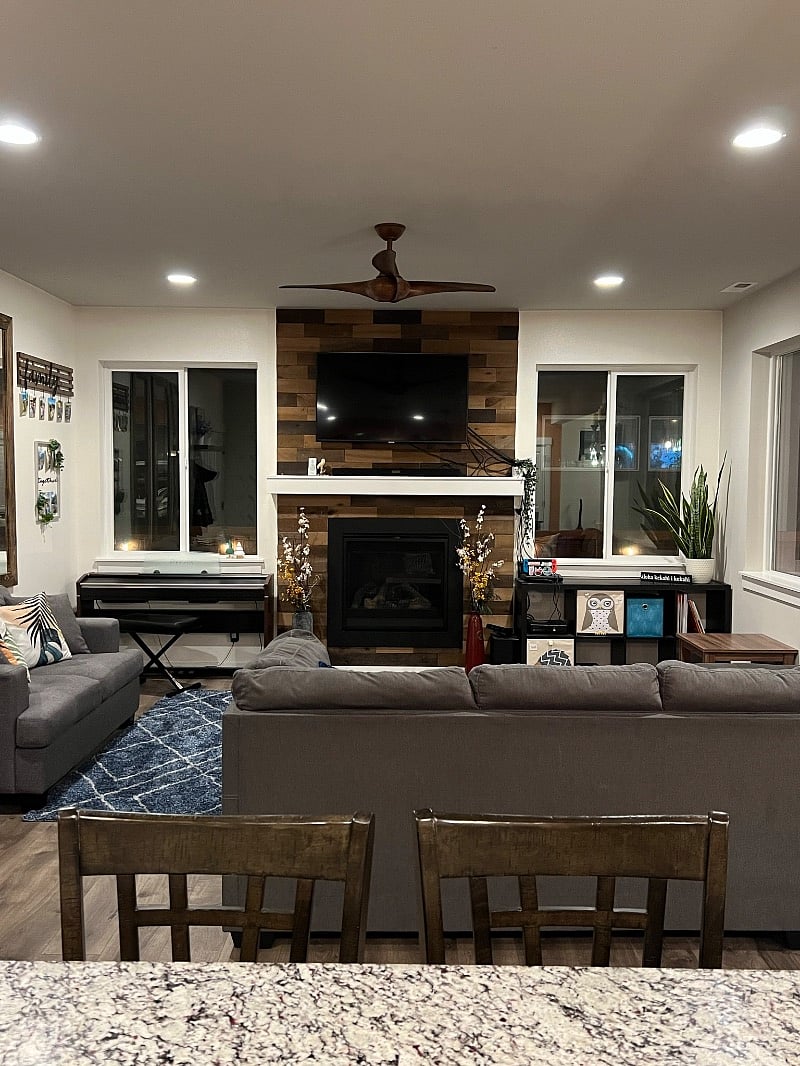 Shared living room, gas fireplace, and accent wall. There is also an electric piano.