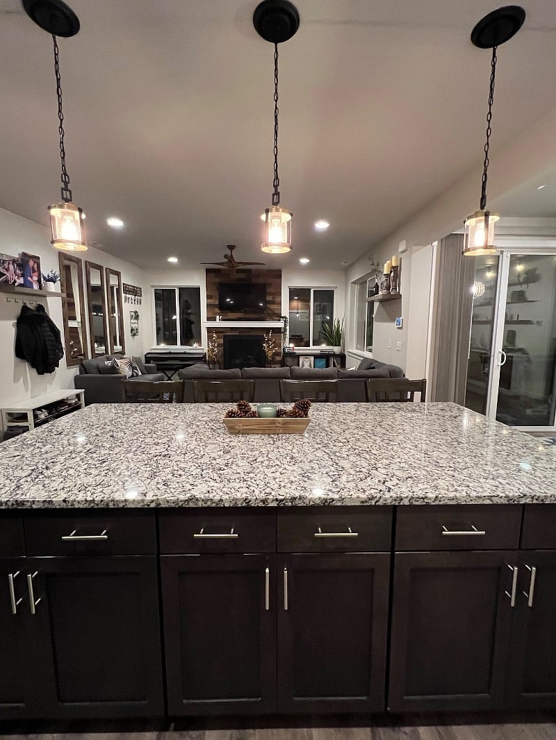 Kitchen island w/ seating for 4 and shared living room.