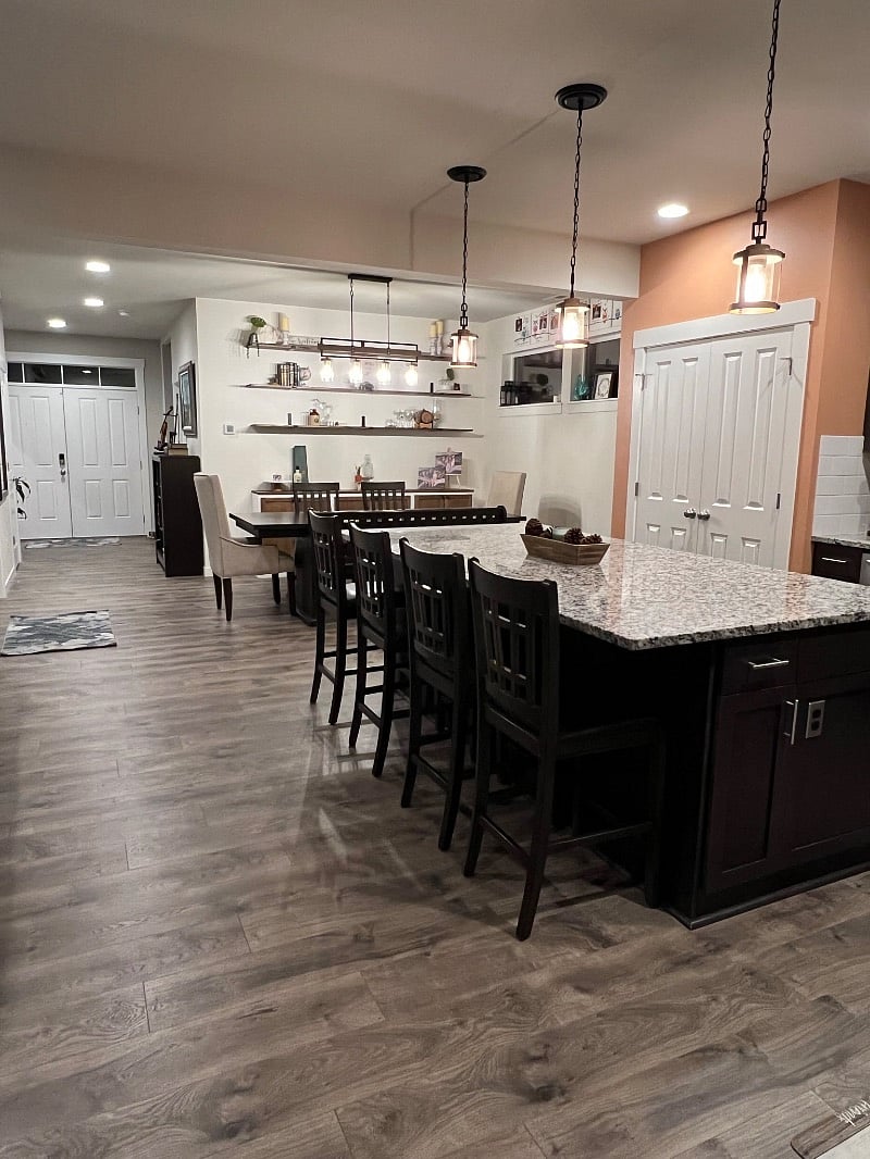 Kitchen island w/ seating for 4 and dining room w/ table and seating for 7.