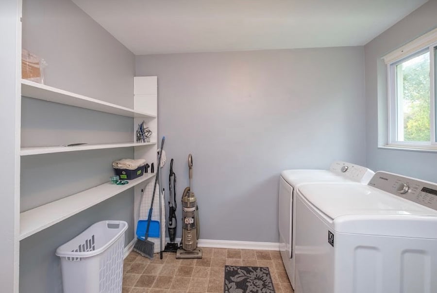 Large separate laundry room with lots of storage space and full size washer and dryer