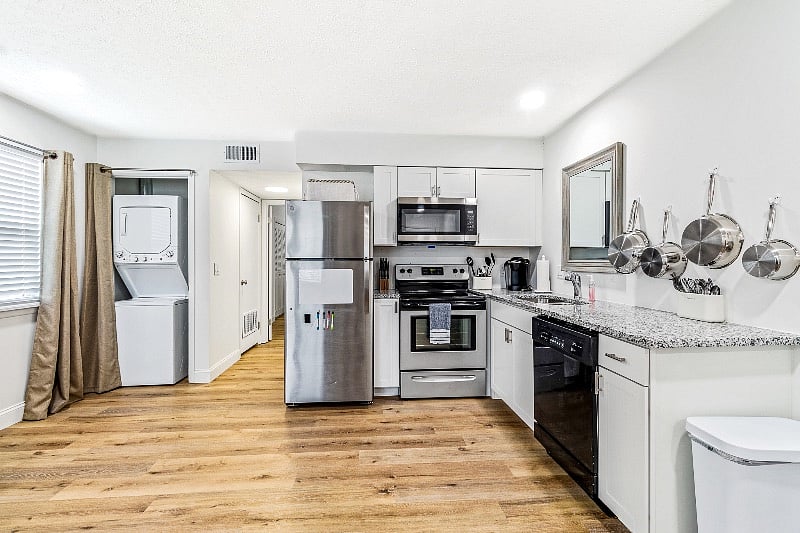 Stacked washer and dryer in closet on letft