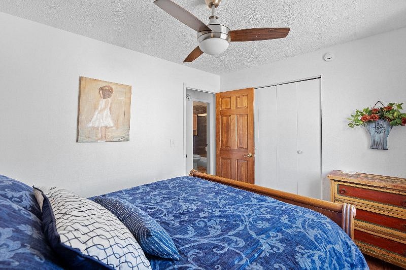 Bedroom with queen size bed and closet.