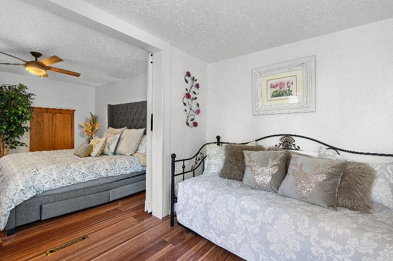 Bedroom with king size bed and adjacent "bonus" room with trundle bed which has two twin size beds that can come together to make another king size bed.