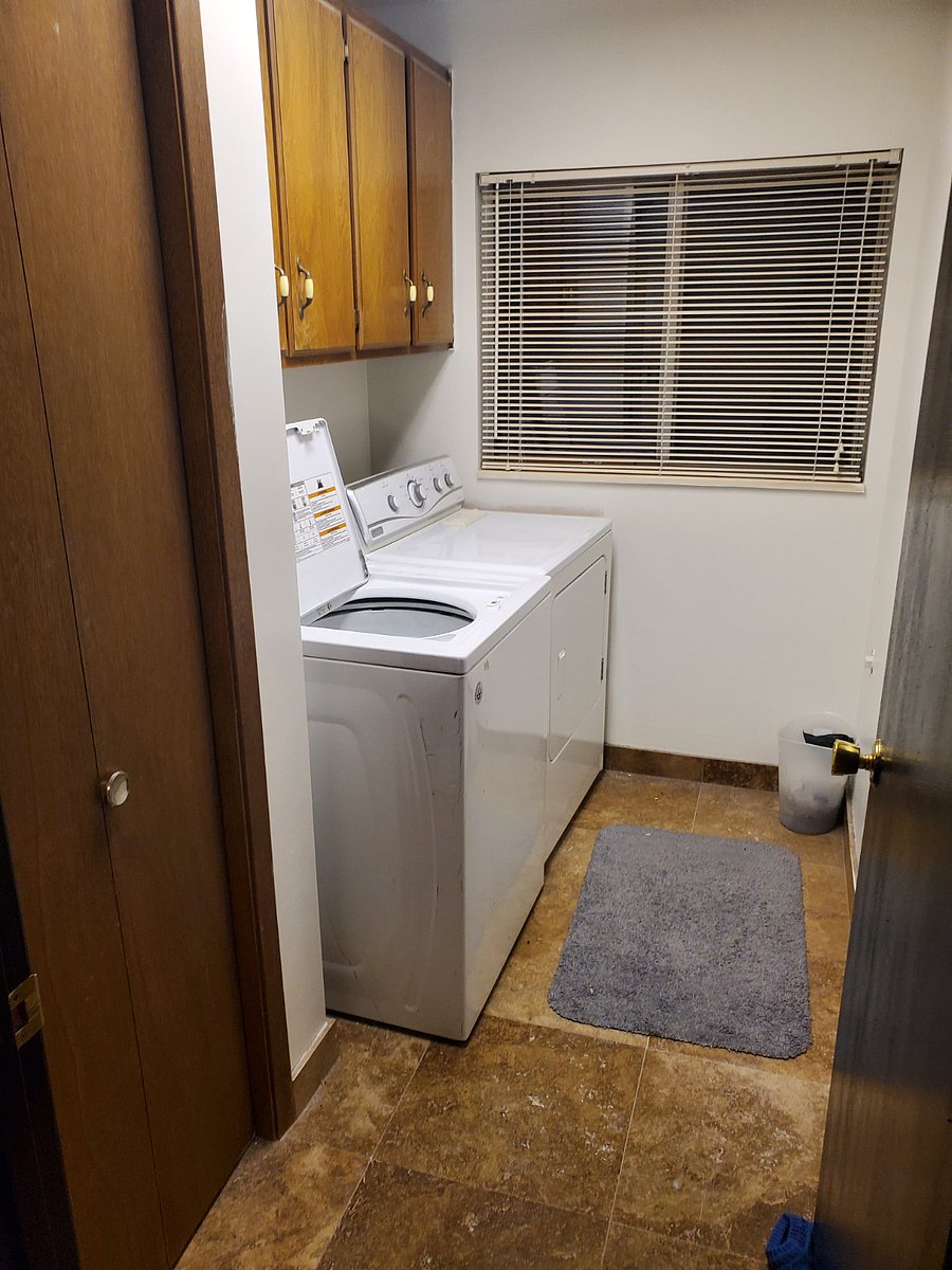 Laundry room located inside main level apartment (between kitchen and hallway full bathroom)