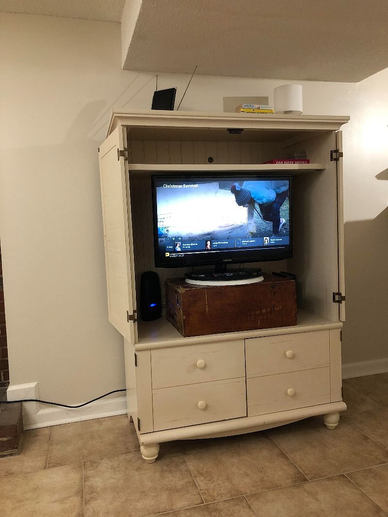 Armoire contains TV with firestick, wifi modem and router, can be closed away when not in use. extra linens stored below.