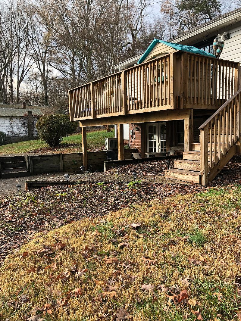 wide view of back upper deck with studio entrance on lower level