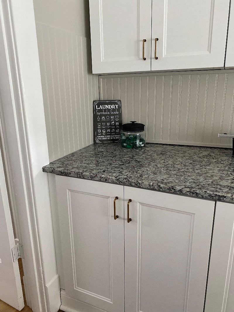 Hidden laundry area behind lower cabinets