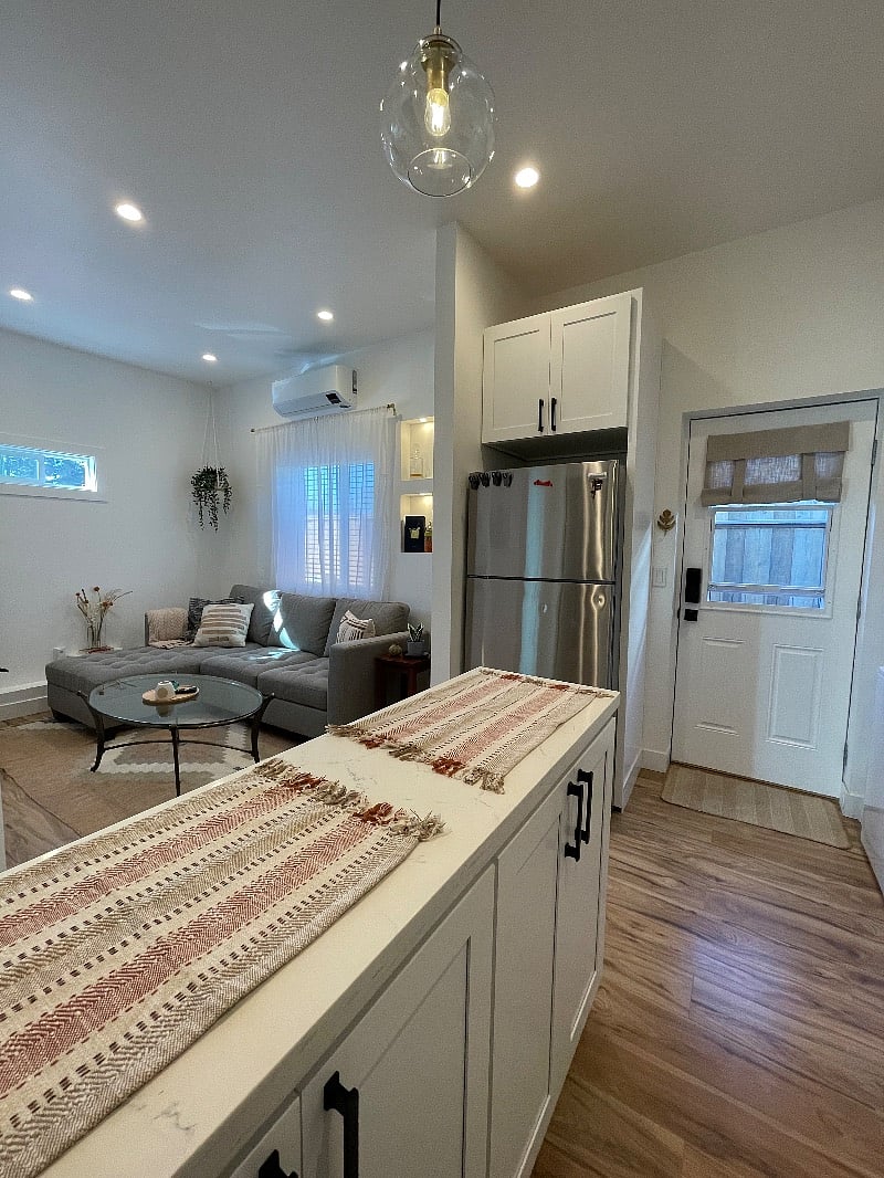 Full-sized fridge and a front door with a window for great lighting and a fresh breeze. Unit is tucked away behind a gate with a code for ultimate privacy. 