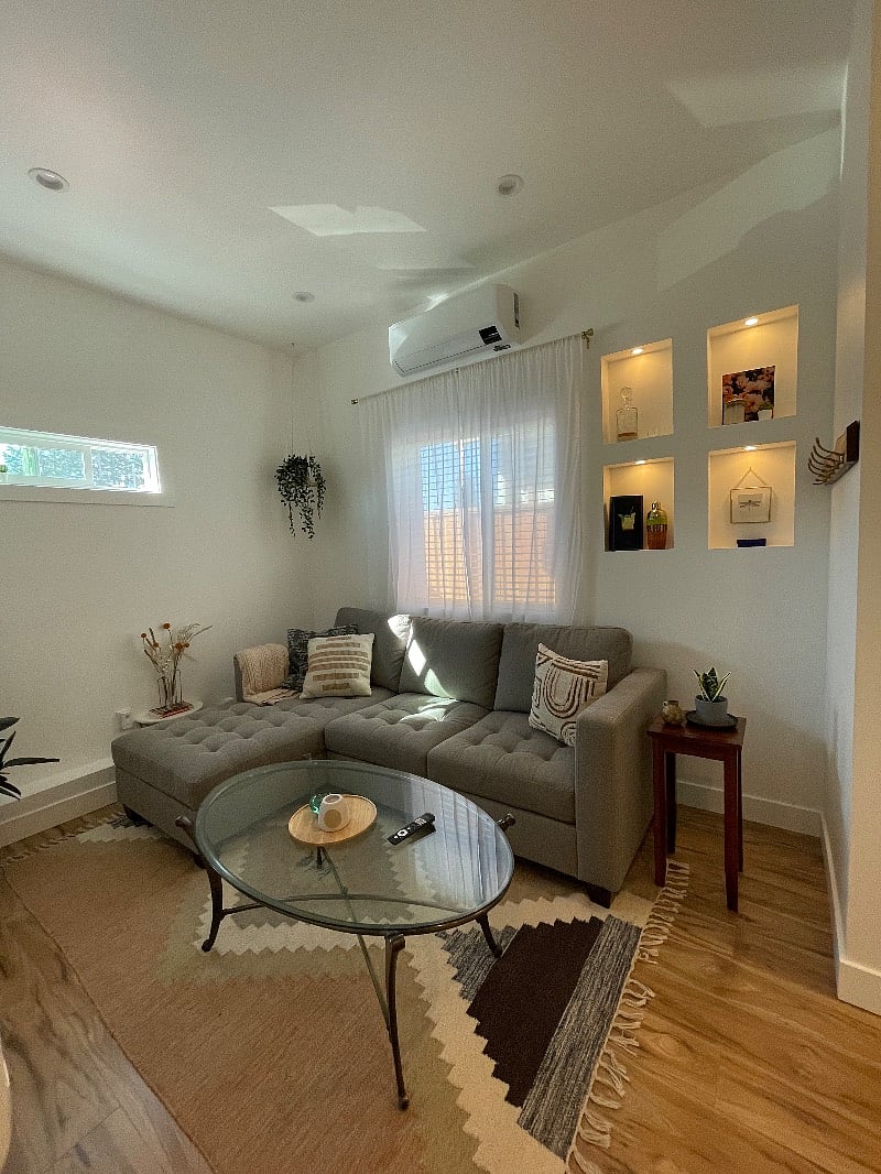 Spacious living room with decadent puck lighting. 