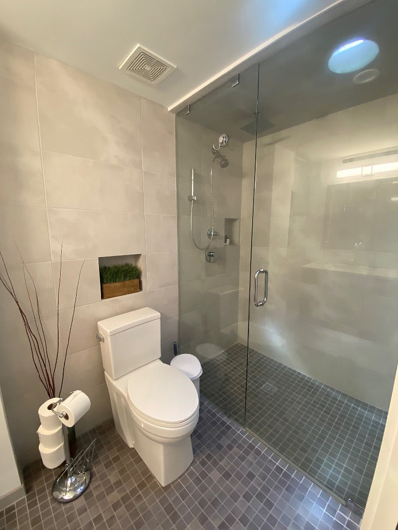 Extra large zero entry shower with hand held wand and rain shower head!   Seamless glass enclosure floor to ceiling enables a steam style sauna / shower.