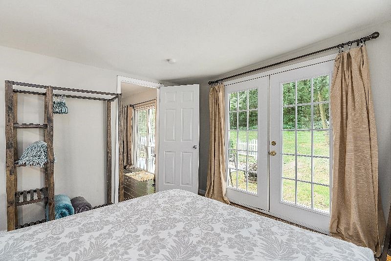 Primary bedroom with view out to rear yard and patio.
